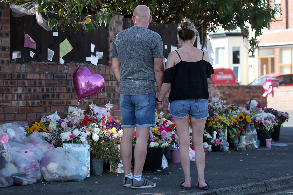 FILE - Floral tributes are left at the site in Southport, England, Aug. 11, 2024 after three young girls were killed in a knife attack at a Taylor Swift-themed holiday club. (AP Photo/Scott Heppell, File)