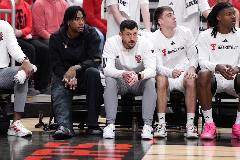 Texas Tech forward JT Toppin, far left, sits on the bench during the first half in an NCAA college basketball game against Kansas State, Saturday, Feb. 21, 2026, in Lubbock, Texas. Toppin is out for the season because of a torn ACL. (AP Photo/Annie Rice)