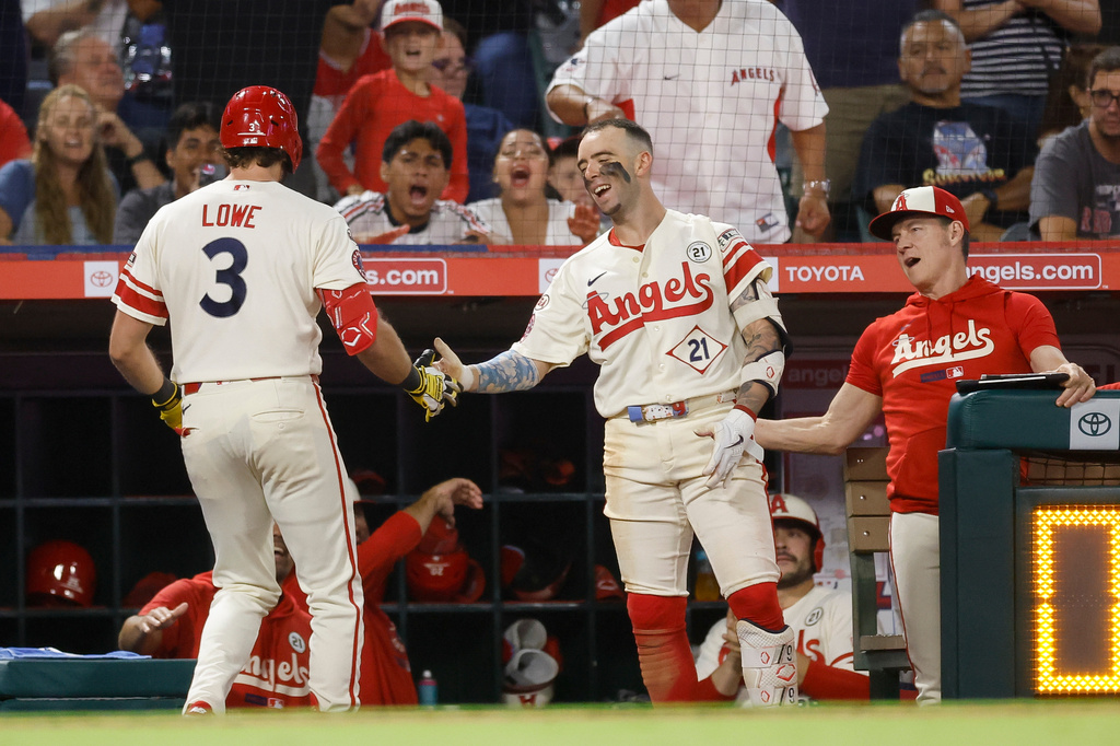 Los Angeles Angels' Josh Lowe (3), left, is greeted by teammates after hitting a solo home run during the sixth inning of a baseball game against the Seattle Mariners, Tuesday, Sept. 15, 2026, in Anaheim, Calif. (AP Photo/Caroline Brehman)