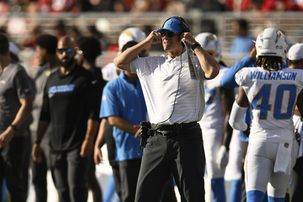 Los Angeles Chargers head coach Jim Harbaugh, middle, watches from the sideline during the first half of an NFL preseason football game against the San Francisco 49ers in Santa Clara, Calif., Saturday, Aug. 23, 2025. (AP Photo/Eakin Howard)