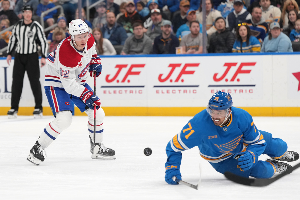 Montreal Canadiens' Owen Beck (62) shoots as St. Louis Blues' Mathieu Joseph (71) defends during the first period of an NHL hockey game Saturday, Jan. 3, 2026, in St. Louis. (AP Photo/Jeff Roberson)