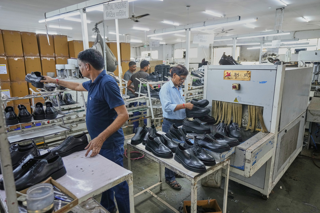 Workers in a manufacturing unit make leather footwear in Agra, India, Monday, Aug. 25, 2025. (AP Photo/Manish Swarup)