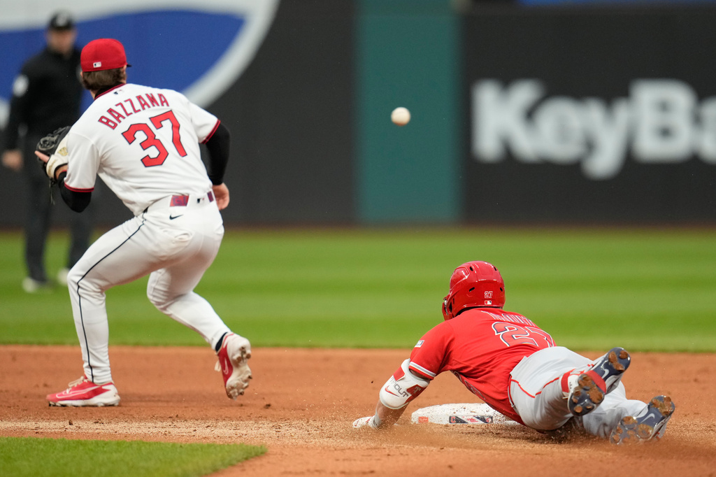 Los Angeles Angels' Mike Trout, right, slides into second base with a double as Cleveland Guardians second baseman Travis Bazzana (37) takes the throw in the fifth inning of a baseball game in Cleveland, Tuesday, May 12, 2026. (AP Photo/Sue Ogrocki)