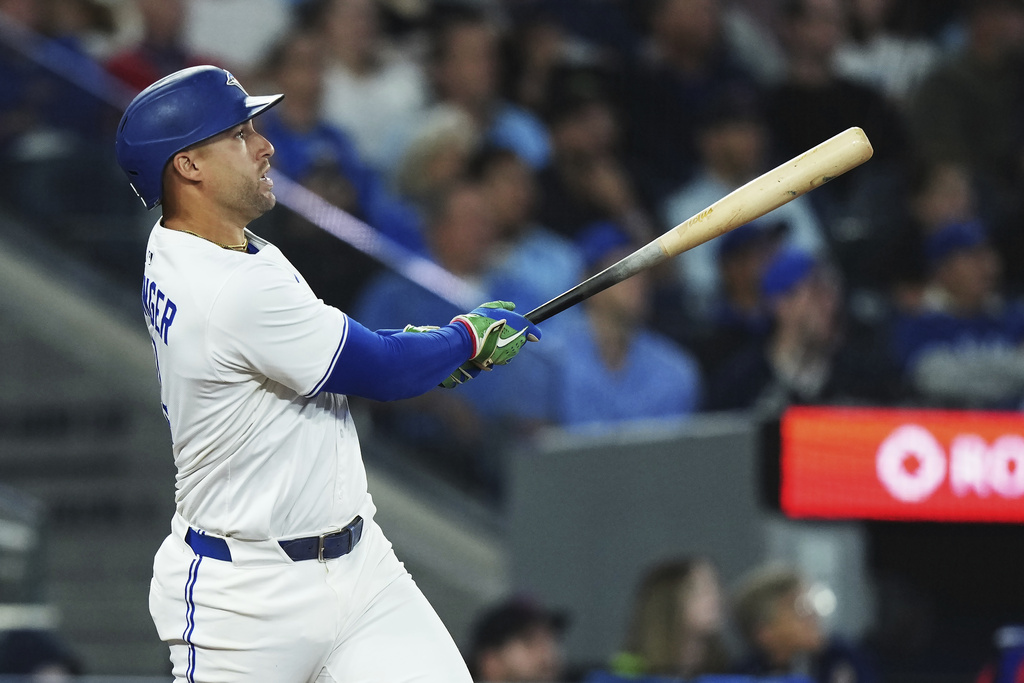 Toronto Blue Jays' George Springer (4) hits a solo home run against the Houston Astros during sixth inning MLB baseball action in Toronto on Tuesday, Sept. 9, 2025. (Nathan Denette/The Canadian Press via AP)