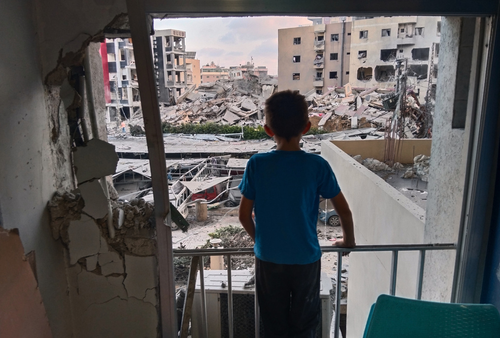 A boy looks through a damaged room of the Jabal Amel Hospital into a destroyed building that was hit in an Israeli airstrike in the southern port city of Tyre, Lebanon, Monday, June 1, 2026. (AP Photo)