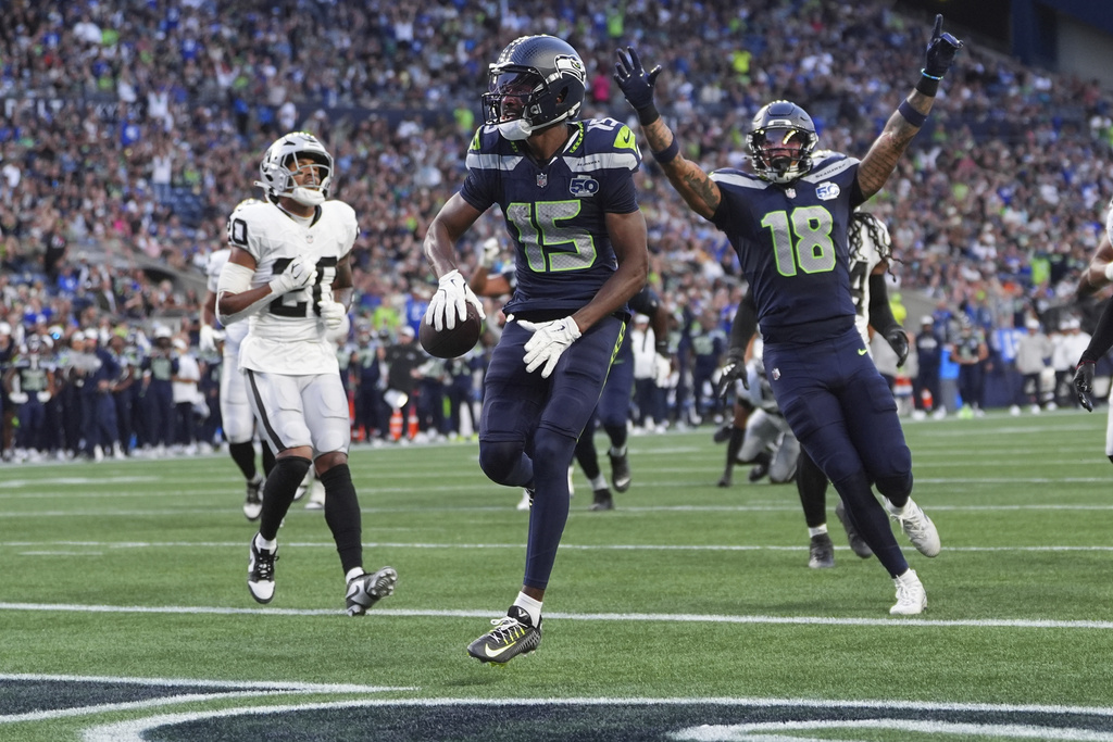 Seattle Seahawks wide receiver Tory Horton (15) scores a touchdown during the first half of an NFL preseason football game against the Las Vegas Raiders, Thursday, Aug. 7, 2025, in Seattle. (AP Photo/Lindsey Wasson)