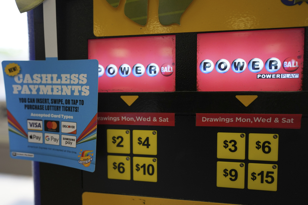 Powerball lottery tickets signs are seen at the lottery vending machine in a convenience store in Northbrook, Ill., Wednesday, Sept. 3, 2025.(AP Photo/Nam Y. Huh)