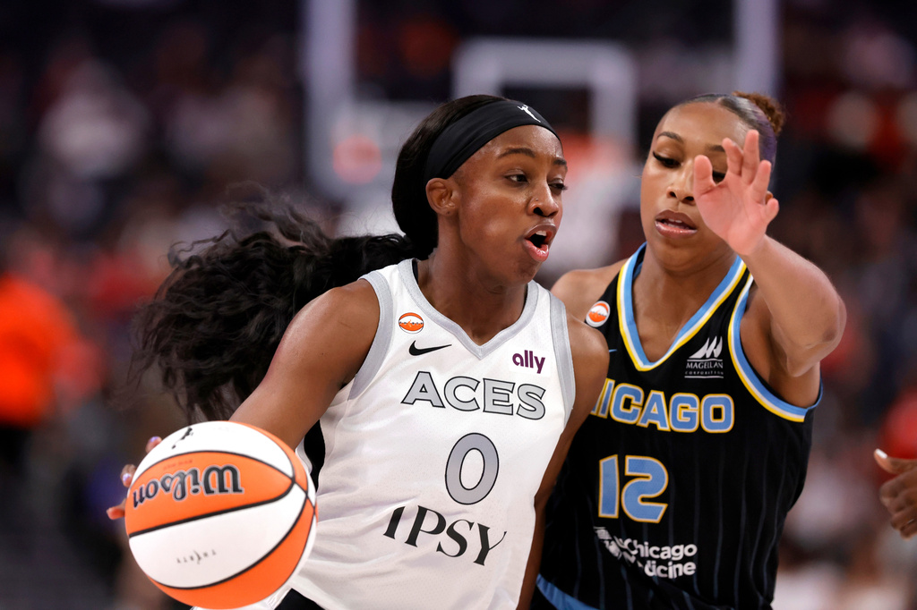 Las Vegas Aces guard Jackie Young (0) drives against Chicago Sky guard Sydney Taylor (12) during the first half of an WNBA basketball game Friday, July 3, 2026, in Las Vegas. (Steve Marcus/Las Vegas Sun via AP)