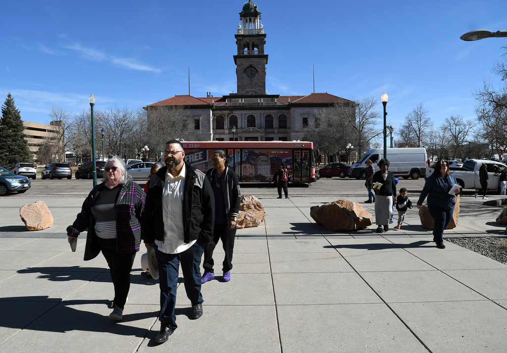 Derrick Johnson, whose mother's body was one of 189 left to decay in the Return to Nature Funeral Home in Penrose, Colo., walks toward the El Paso County Courthouse for owner Jon Hallford's sentencing in Colorado Springs, Colo., Friday, Feb. 6, 2026. (AP Photo/Thomas Peipert)