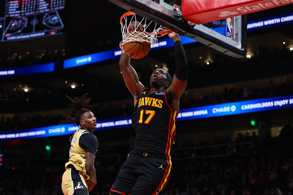 Atlanta Hawks forward Onyeka Okongwu (17) dunks against Washington Wizards guard Jamir Watkins, left, during the first half of an NBA basketball game, Tuesday, Feb. 24, 2026, in Atlanta. (AP Photo/Colin Hubbard)