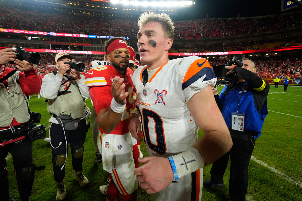 Kansas City Chiefs quarterback Chris Oladokun, left, talks with Denver Broncos quarterback Bo Nix following an NFL football game Thursday, Dec. 25, 2025, in Kansas City. (AP Photo/Charlie Riedel)