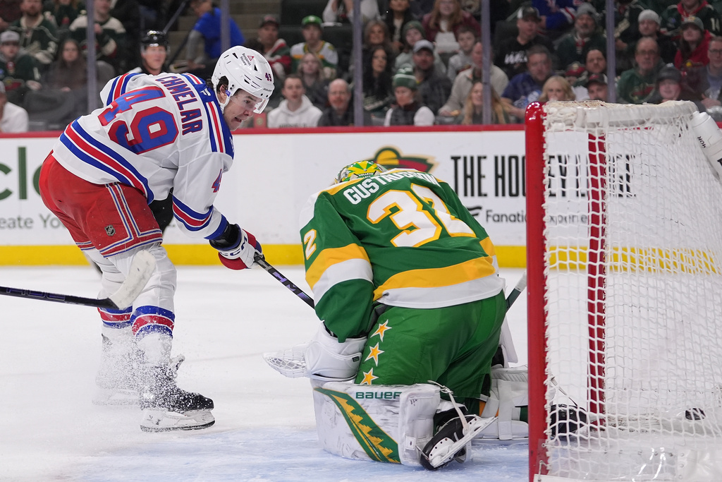 New York Rangers right wing Jaroslav Chmelar (49) scores a goal past Minnesota Wild goaltender Filip Gustavsson (32) during the second period of an NHL hockey game, Saturday, March 14, 2026, in St. Paul, Minn. (AP Photo/Abbie Parr)