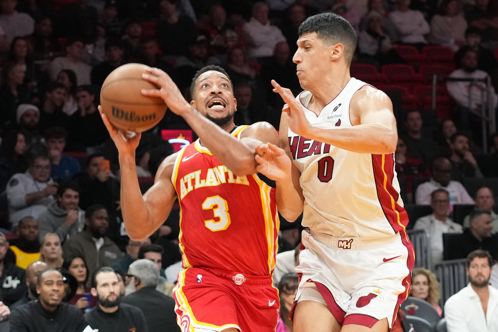 Atlanta Hawks guard CJ McCollum (3) drives to the basket as Miami Heat forward Simone Fontecchio (0) defends during the first half of an NBA basketball game Tuesday, Feb. 3, 2026, in Miami. (AP Photo/Marta Lavandier)