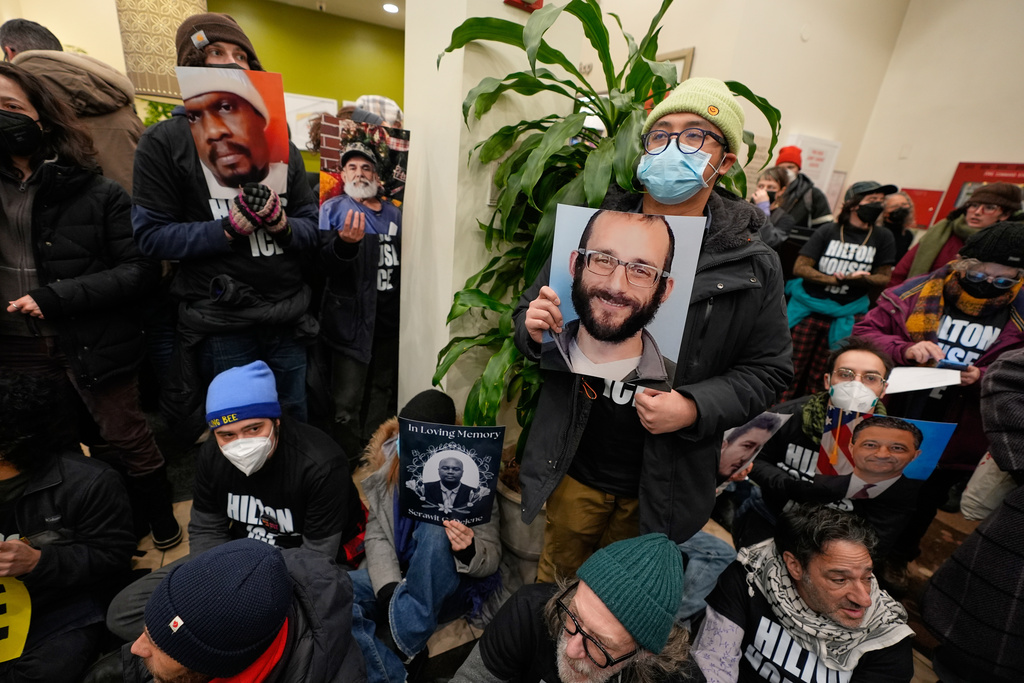 Protesters stage a sit-in in the lobby of a Hilton Garden Inn in New York, Tuesday, Jan. 27, 2026. (AP Photo/Seth Wenig)
