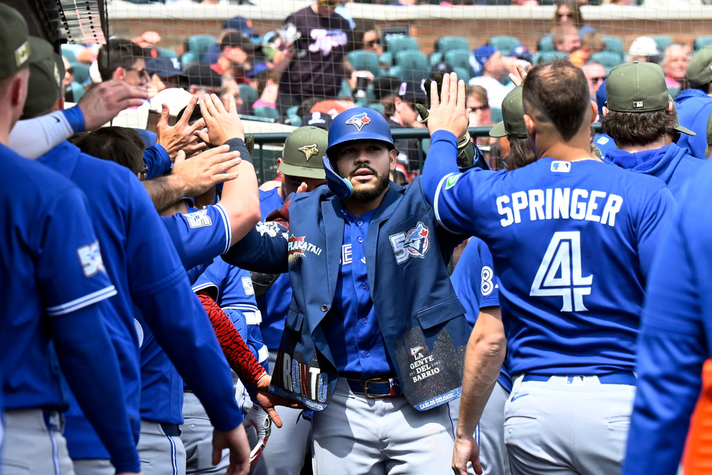 Toronto Blue Jays' Yohendrick Piñango, center, is congratulated in the dugout after hitting a home run during the seventh inning of a baseball game against the Detroit Tigers, Saturday, May 16, 2026, in Detroit. (AP Photo/Jose Juarez)
