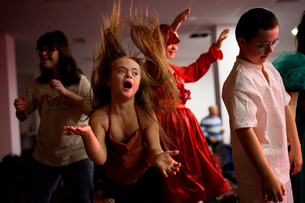 Sophia Lupu, centre, dances on the catwalk at the end of the SEEN Anonymous Seamstresses Gala, an event organised by the Down Plus Bucharest, an NGO supporting youngsters with Down Syndrome and other intellectual disabilities, in Bucharest, Romania, Wednesday, March 18, 2026, ahead of the World Down Syndrome Day, on March 21. (AP Photo/ Vadim Ghirda)
