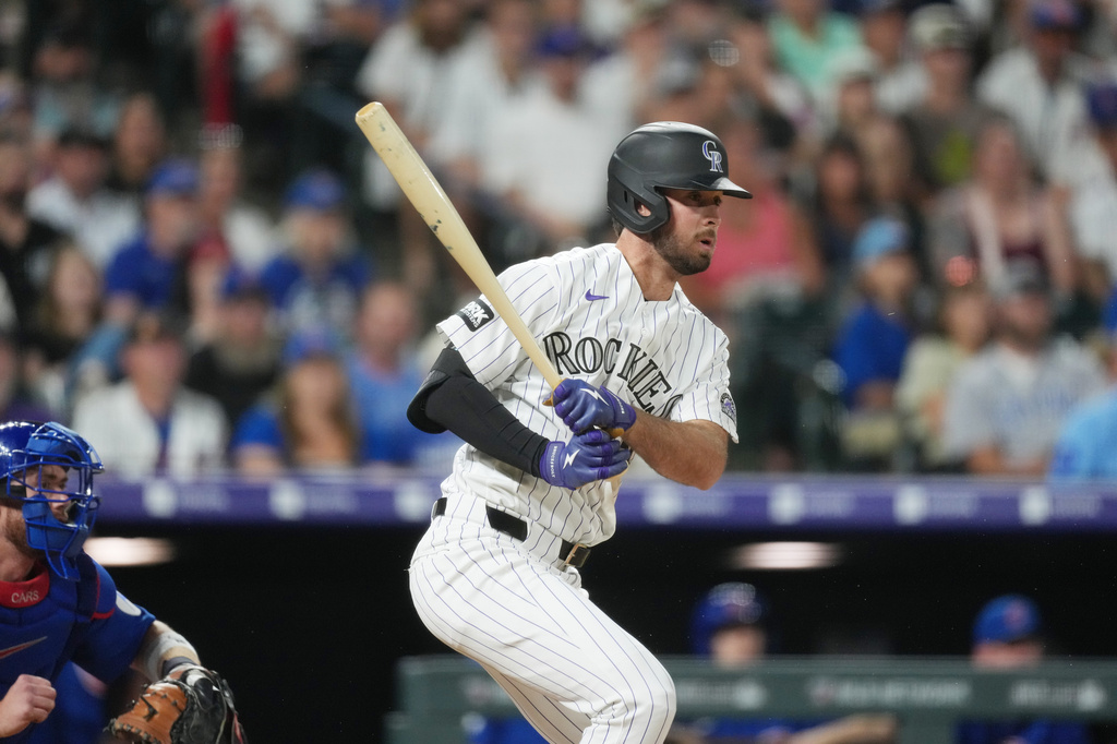 Colorado Rockies pinch-hitter Sterlin Thompson follows the flight of his walkoff, RBI single off Chicago Cubs relief pitcher Daniel Palencia in the ninth inning of a baseball game, Wednesday, June 10, 2026, in Denver. (AP Photo/David Zalubowski)