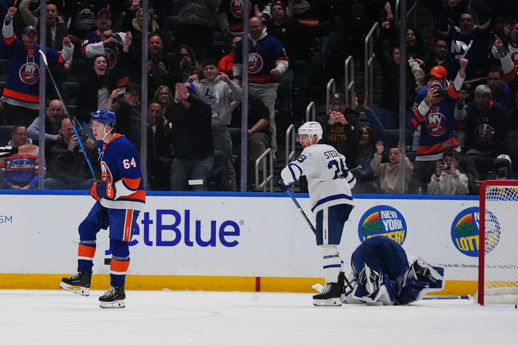 New York Islanders' Calum Ritchie (64) celebrates after scoring a goal as Toronto Maple Leafs' Troy Stecher (28) and Toronto Maple Leafs goaltender Artur Akhtyamov react during the third period of an NHL hockey game Thursday, April 9, 2026, in Elmont, N.Y. (AP Photo/Frank Franklin II)