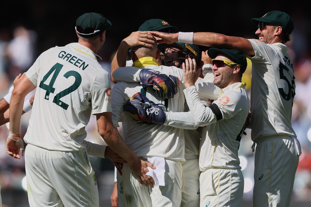 Australia's Nathan Lyon, second left, is congratulated by teammates after dismissing England's Ben Stokes during play on day four of the third Ashes cricket test between England and Australia in Adelaide, Australia, Saturday, Dec. 20, 2025. (AP Photo/James Elsby)