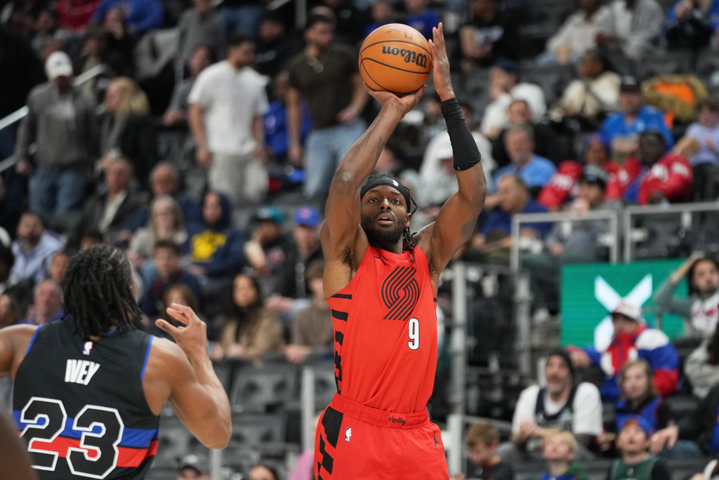 Portland Trail Blazers forward Jerami Grant, right, shoots against Detroit Pistons guard Jaden Ivey during the first half of an NBA basketball game, Friday, Dec. 5, 2025, in Detroit. (AP Photo/Ryan Sun)