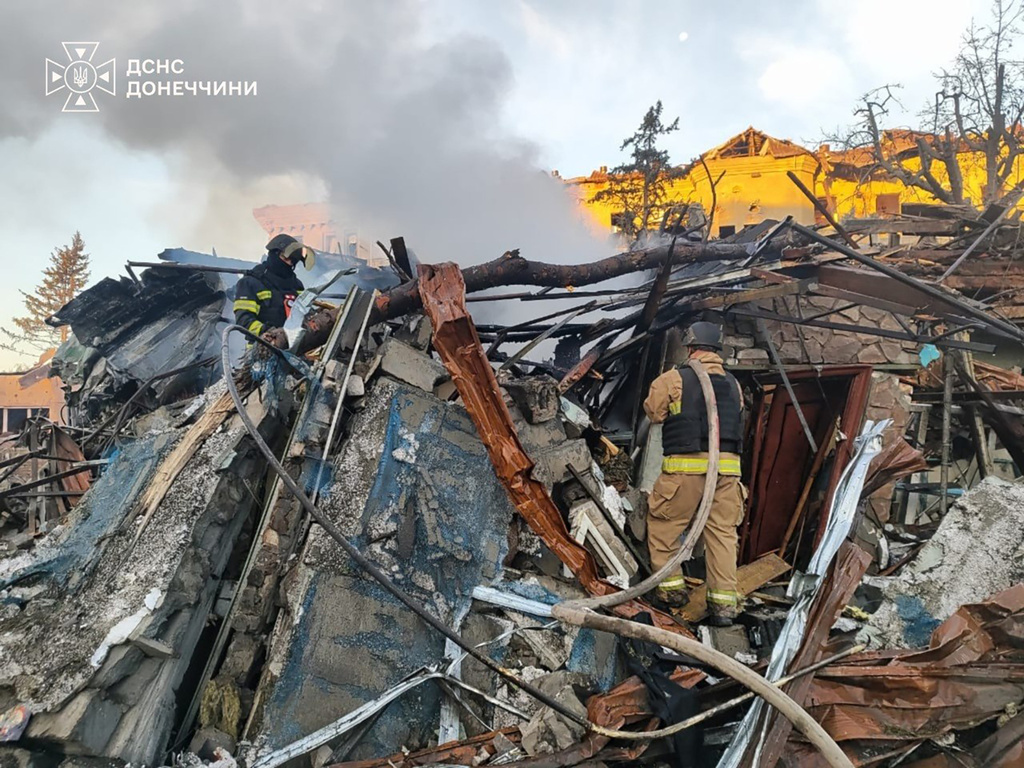 In this photo provided by the Ukrainian Emergency Service, emergency services personnel work to extinguish a fire following a Russian guided bomb strike in the city center of Sloviansk, Donetsk region, Ukraine, Monday, Aug. 31, 2026. (Ukrainian Emergency Service via AP)