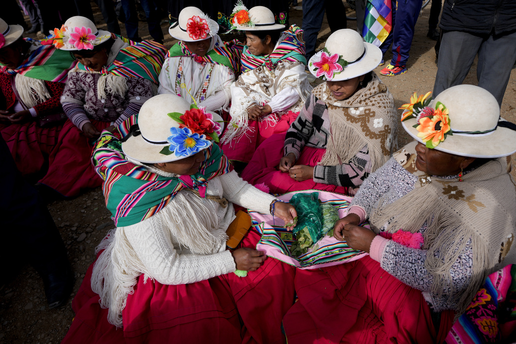 FILE - Demonstrators chew coca leaves prior to marching to the capital, in Caracollo, Bolivia, Sept. 17, 2024. (AP Photo/Juan Karita)