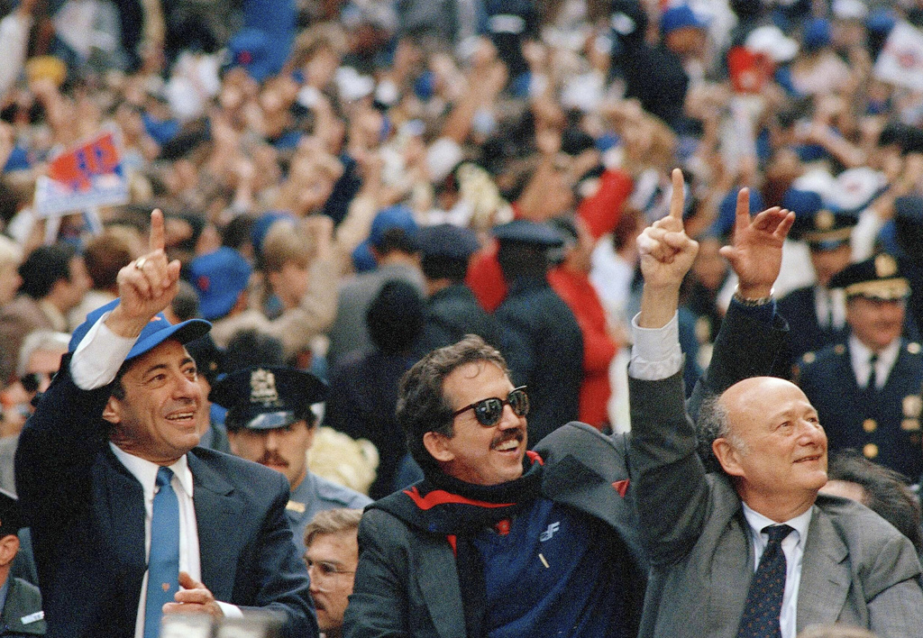 FILE - New York Gov. Mario Cuomo, left, New York Mets Manager Davey Johnson, center, and New York Mayor Ed Koch, raise their hands signaling "number one" during a tickertape parade for the World Series winners in downtown Manhattan, New York, Oct. 28, 1986, in New York. (AP Photo/Mario Cabrera, File)