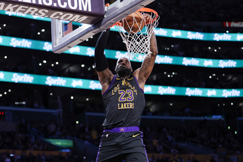 Los Angeles Lakers forward LeBron James (23) dunks against the Phoenix Suns during the second half of an NBA basketball game, Friday, April 10, 2026, in Los Angeles. (AP Photo/Jessie Alcheh)