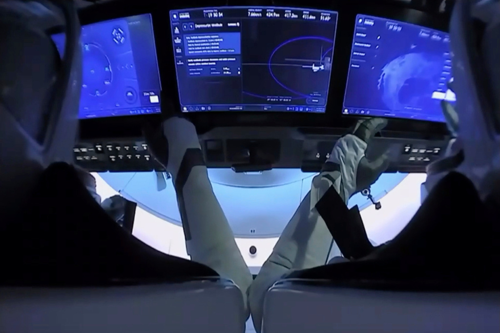 FILE - In this image from video provided by NASA, astronauts Doug Hurley, left, and Bob Behnken prepare for undocking from the International Space Station, aboard the SpaceX Crew Dragon capsule on Saturday, Aug. 1, 2020. (NASA via AP, File)