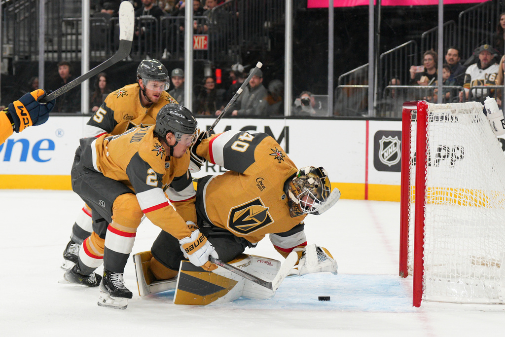 Vegas Golden Knights goaltender Akira Schmid (40) stops a shot from the Nashville Predators during the first period of an NHL hockey game, Wednesday, Dec. 31, 2025, in Las Vegas. (AP Photo/Candice Ward)
