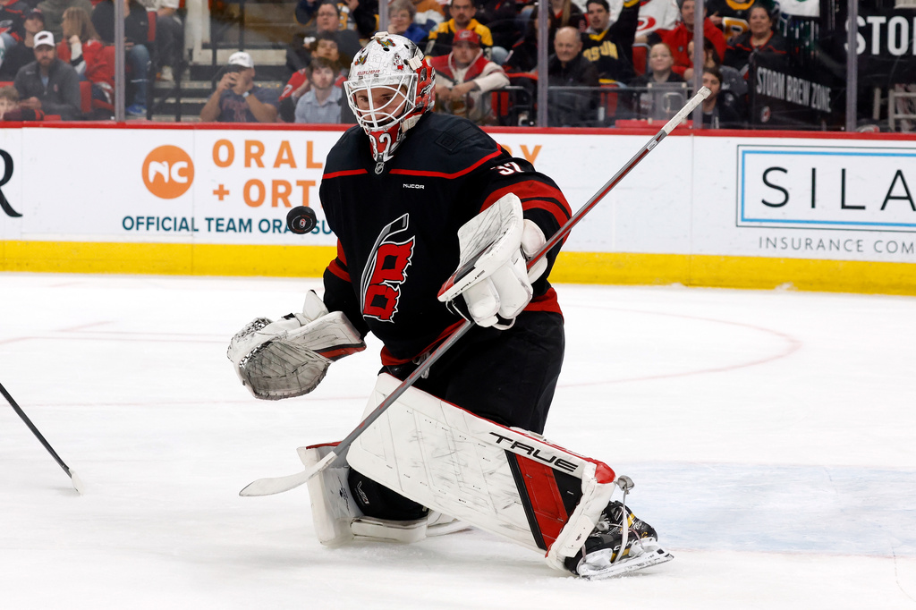 Carolina Hurricanes goaltender Brandon Bussi (32) eyes the puck against the Boston Bruins during the first period of an NHL hockey game in Raleigh, N.C., Tuesday, April 7, 2026. (AP Photo/Karl DeBlaker)