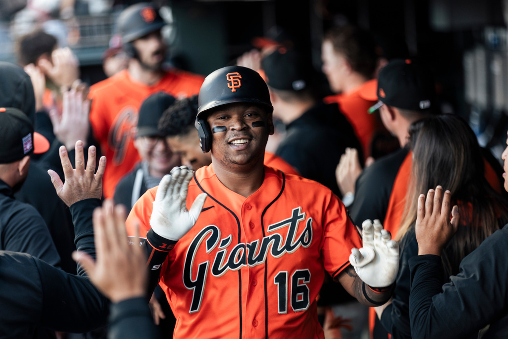 San Francisco Giants' Rafael Devers (16) high-fives teammates in the dugout after hitting a two-run home run during the first inning of a MLB baseball game against the Los Angeles Angels in San Francisco, Friday, July 24, 2026. (Stephen Lam/San Francisco Chronicle via AP)