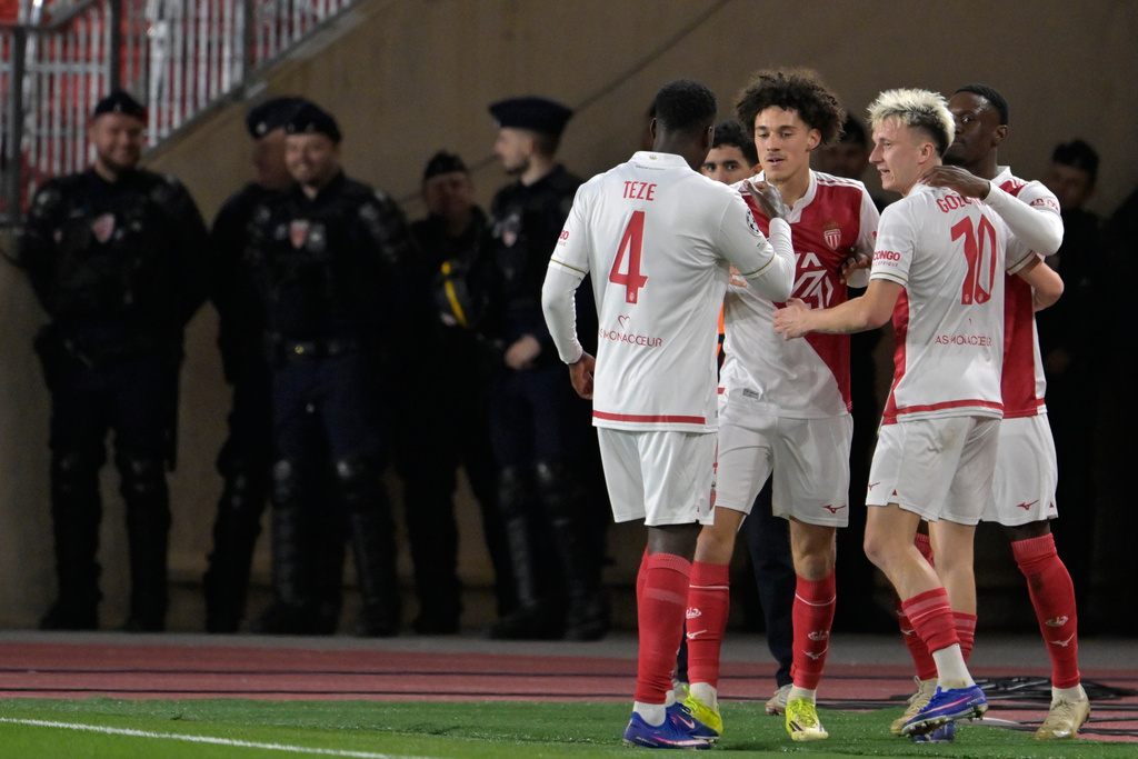 Monaco's Folarin Balogun celebrates with teammates after scoring his side's second goal during the first-leg of the Champions League playoff soccer match between Monaco and Paris Saint-Germain in Monaco, Tuesday, Feb. 17, 2026. (AP Photo/Philippe Magoni)