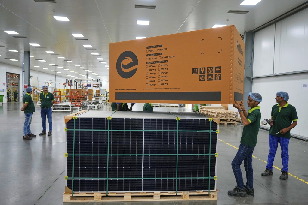 Workers pack solar panels at a ReNew manufacturing plant on the outskirts of Jaipur, India, Thursday, Aug. 21, 2025. (AP Photo/Manish Swarup)