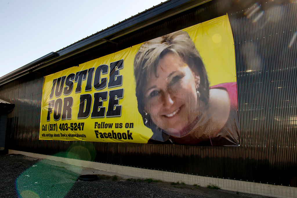 FILE - A banner shows a photo of missing woman Dee Warner in Tipton, Mich., May 9, 2022. (Jacob Hamilton/Jackson Citizen Patriot via AP, File)