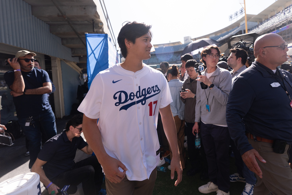 Los Angeles Dodgers two-way player Shohei Ohtani leaves after talking to reporters during DodgerFest at Dodger Stadium in Los Angeles, Saturday, Jan. 31, 2026. (AP Photo/Jae C. Hong)