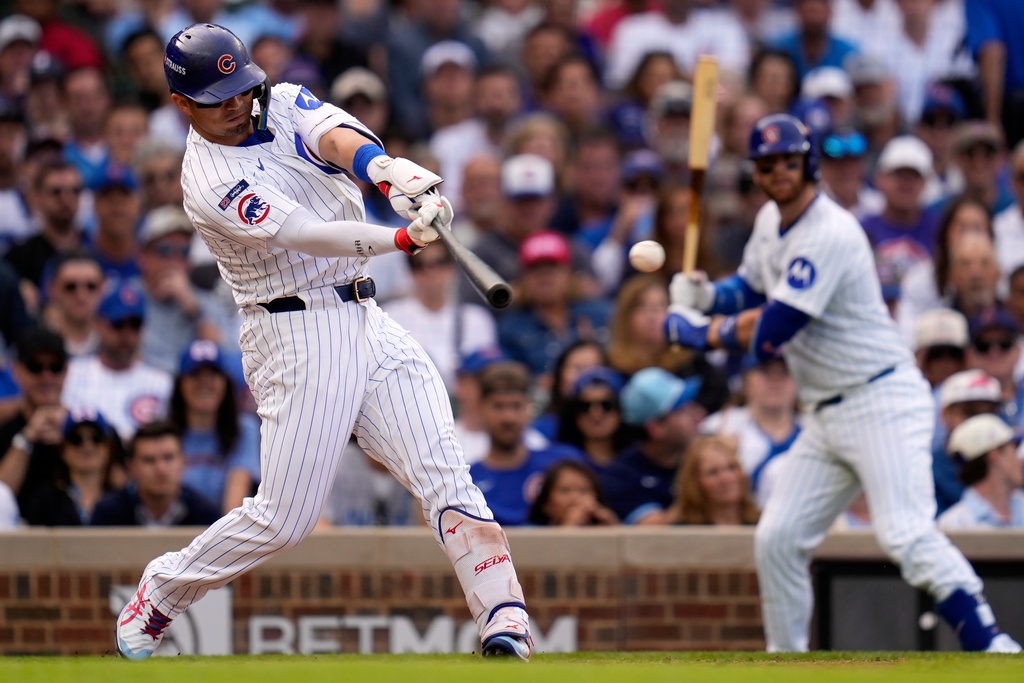 Chicago Cubs' Seiya Suzuki hits a double during the fourth inning of Game 2 of a National League wild card baseball game against the San Diego Padres Wednesday, Oct. 1, 2025, in Chicago. (AP Photo/Erin Hooley)