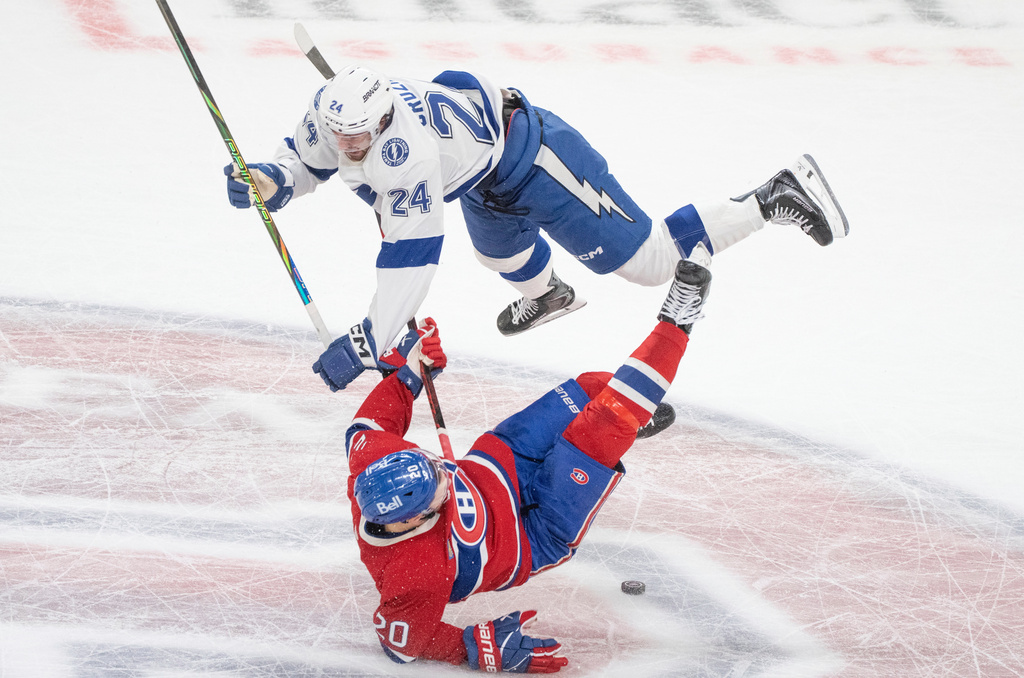 Tampa Bay Lightning's Max Crozier (24) checks Montreal Canadiens' Juraj Slafkovsky (20) during the second period of Game 4 in a first-round NHL hockey Stanley Cup playoff series in Montreal, Sunday, April 26, 2026. (Christinne Muschi/The Canadian Press via AP)