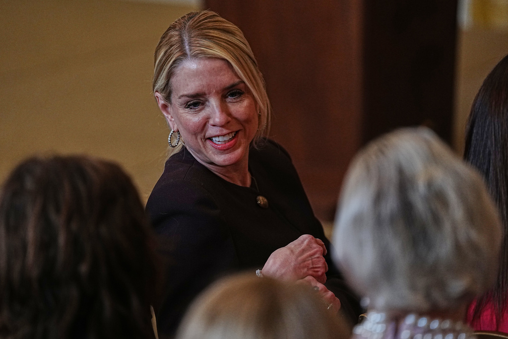 Attorney General Pam Bondi arrives before President Donald Trump attends a women's history month event in the East Room at the White House, Thursday, March 12, 2026, in Washington. (AP Photo/Allison Robbert)