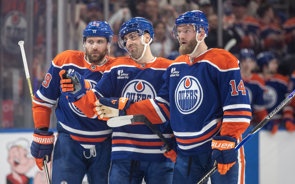 Edmonton Oilers' Leon Draisaitl (29), Evan Bouchard, center, and Mattias Ekholm (14) celebrate after a goal against the Washington Capitals during second-period NHL hockey game action in Edmonton, Alberta, Saturday, Jan. 24, 2026. (Jason Franson/The Canadian Press via AP)