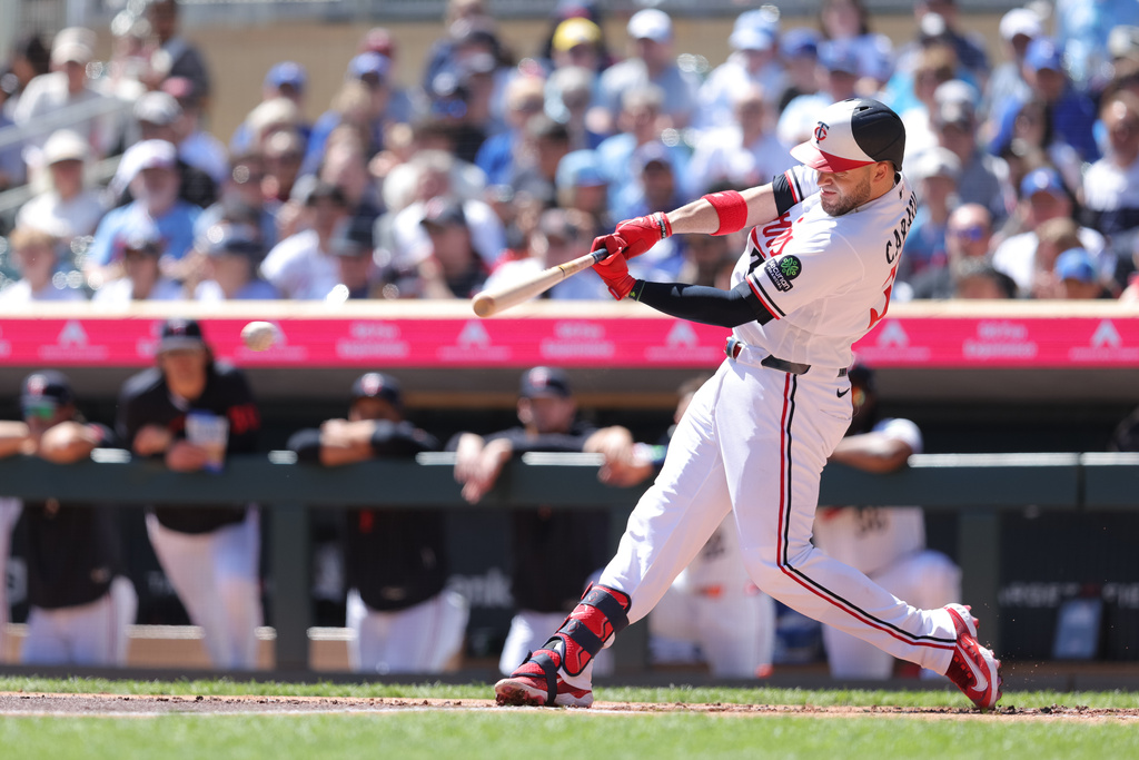 Minnesota Twins' Victor Caratini hits an RBI-single during the first inning of a baseball game against the Toronto Blue Jays, Sunday, May 3, 2026, in Minneapolis. (AP Photo/Bailey Hillesheim)