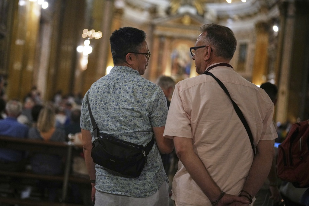 Justin Del Rosario, left, and John Capozzi attend attend a vigil prayer for members of the LGBTQ+ community in the Church of the Gesu' in central Rome, Friday, Sept. 5, 2025. (AP Photo/Andrew Medichini)
