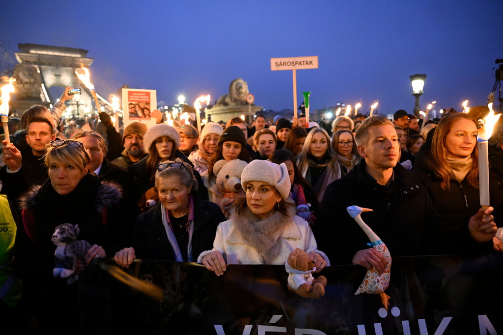 Chairman of the Hungarian opposition Tisza Party Peter Magyar, second righ, Vice Chairman of Tisza Party Agnes Forsthoffer, right, and opera singer Andrea Rost, the party's parliamentary candidate for Jasz-Nagykun-Szolnok County Constituency 1, third from right, attend the Tisza Party demonstration in support of abused children at the Buda Castle Tunnel, in Budapest, Hungary, Saturday, Dec. 13, 2025. (Robert Hegedus/MTI via AP)