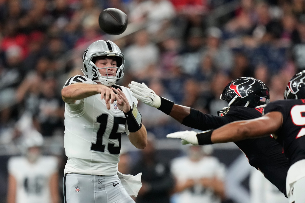 Las Vegas Raiders quarterback Fernando Mendoza (15) throws against the Houston Texans while under pressure during the first half of an NFL preseason football game, Thursday, Aug. 20, 2026, in Houston. (AP Photo/Ashley Landis)