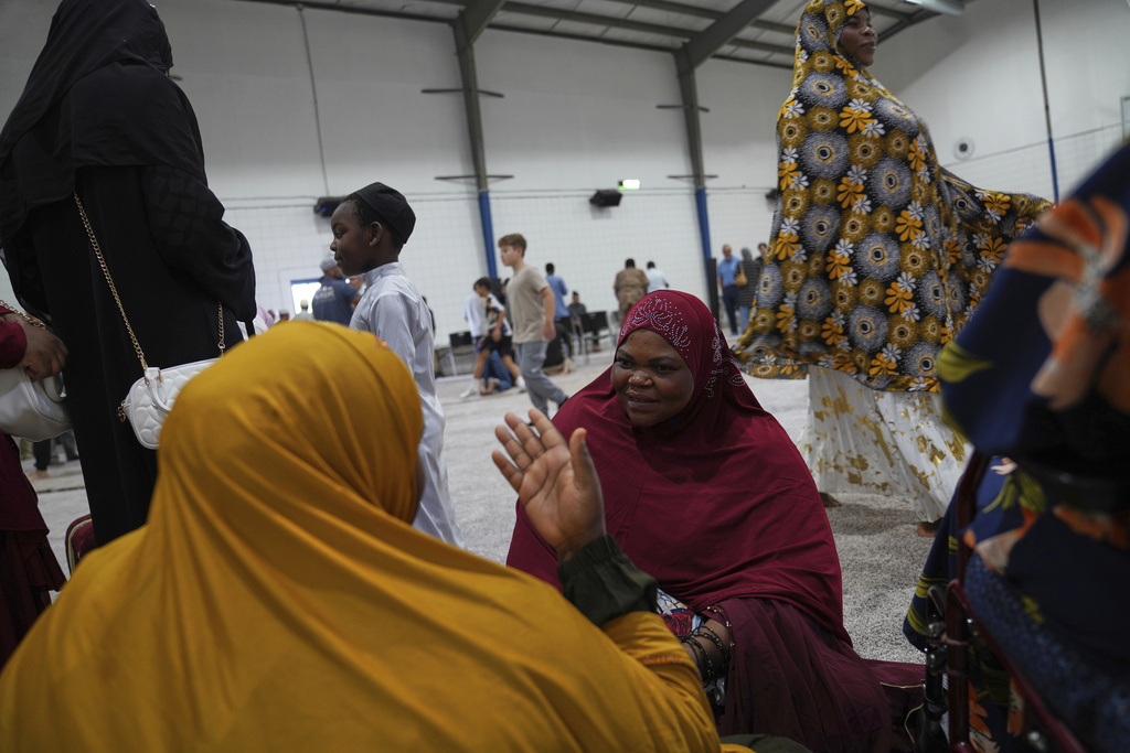 Community members talk after Friday prayer at the Islamic Center of Cedar Rapids on Friday, Aug. 8, 2025, in Cedar Rapids, Iowa. (AP Photo/Jessie Wardarski)