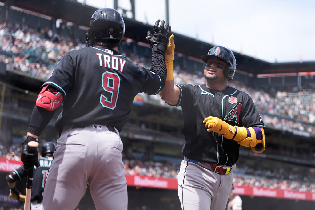 Arizona Diamondbacks' Gabriel Moreno, right, is congratulated by Tommy Troy (9) after hitting a home run against the San Francisco Giants during the third inning of a baseball game Monday, May 25, 2026, in San Francisco. (AP Photo/Jeff Chiu)