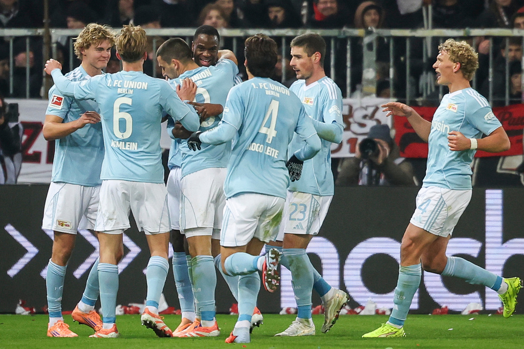 Union's scorer Rani Khedira, third left, and his teammates celebrate the opening goal during the German Bundesliga Soccer match between 1. FC St. Pauli and 1. FC Union Berlin in Hamburg, Germany, Sunday, Nov. 23, 2025. (Christian Charisius/dpa via AP)