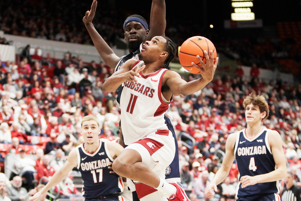 Washington State guard Jerone Morton (11) shoots while pressured by Gonzaga forward Graham Ike, back, during the first half of an NCAA college basketball game, Thursday, Jan. 15, 2026, in Pullman, Wash. (AP Photo/Young Kwak)