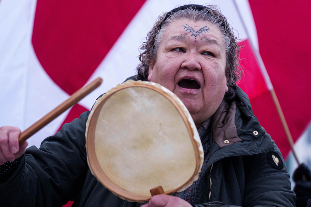 An Inuit woman sings a national song during a protest against Trump's policy towards Greenland in front of the US consulate in Nuuk, Greenland, Saturday, Jan. 17, 2026. (AP Photo/Evgeniy Maloletka)