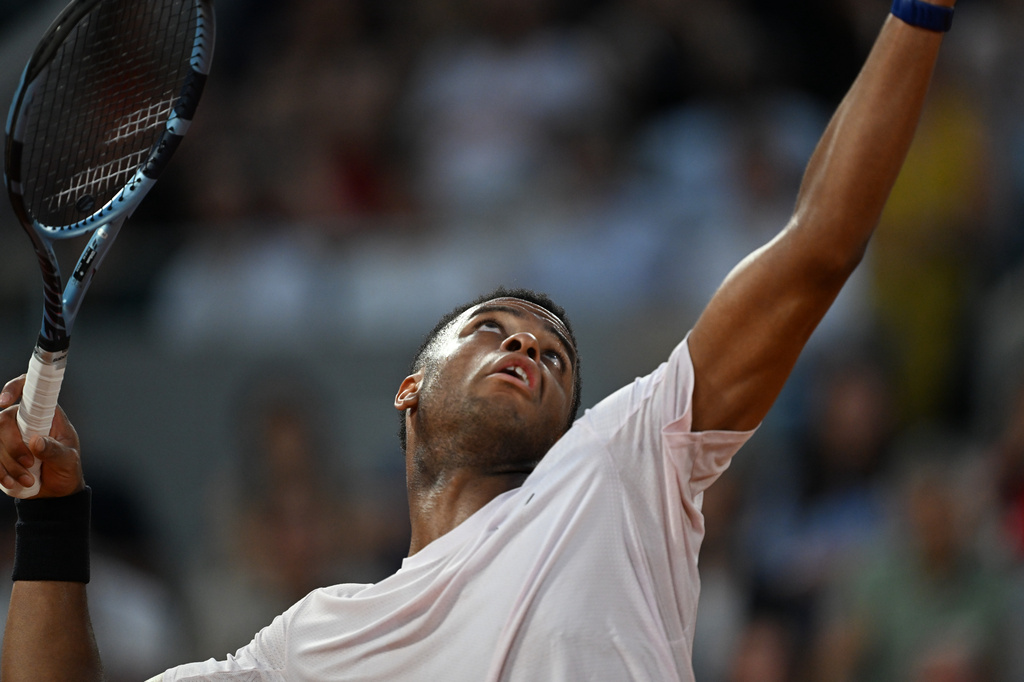 Giovanni Mpetshi Perricard of France serves to Novak Djokovic of Serbia during their first round men's singles tennis match at the French Open tennis tournament in Paris, Sunday, May 24, 2026. (AP Photo/Emma Da Silva)